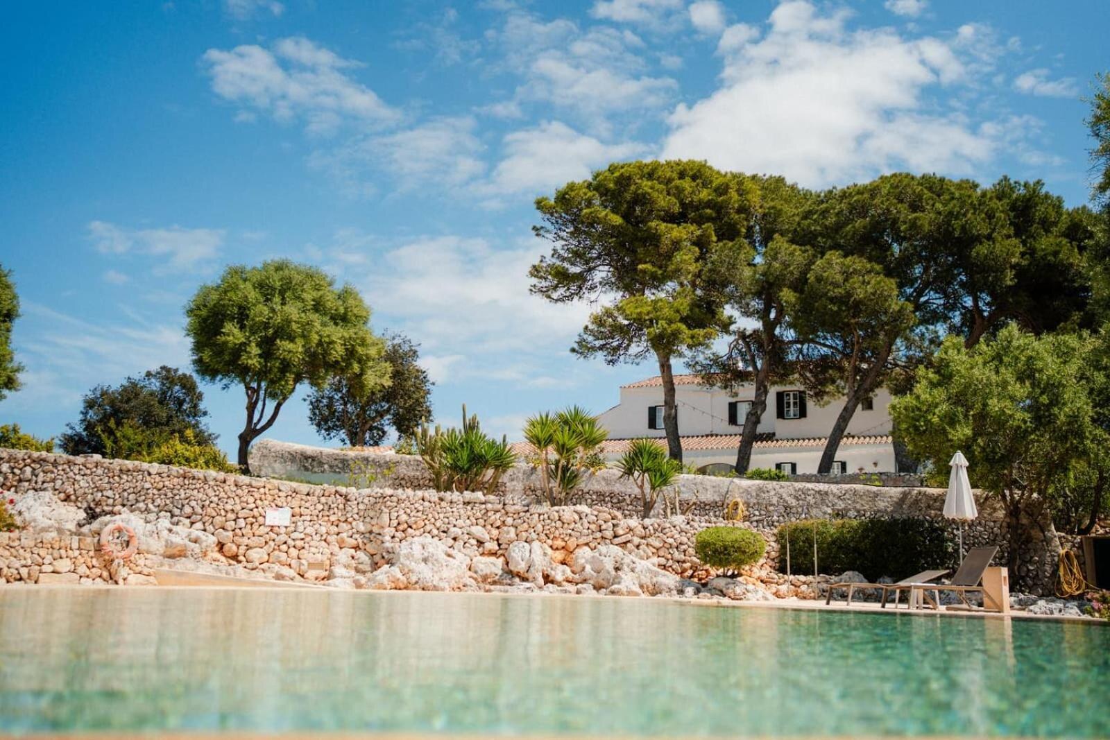 Biniguas Vell &mdash; the pool beneath the finca, framed by pines