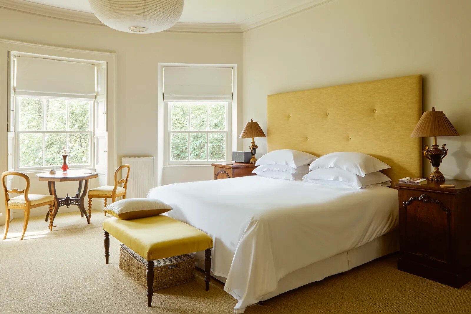 Boath House — a bedroom with a yellow upholstered headboard
