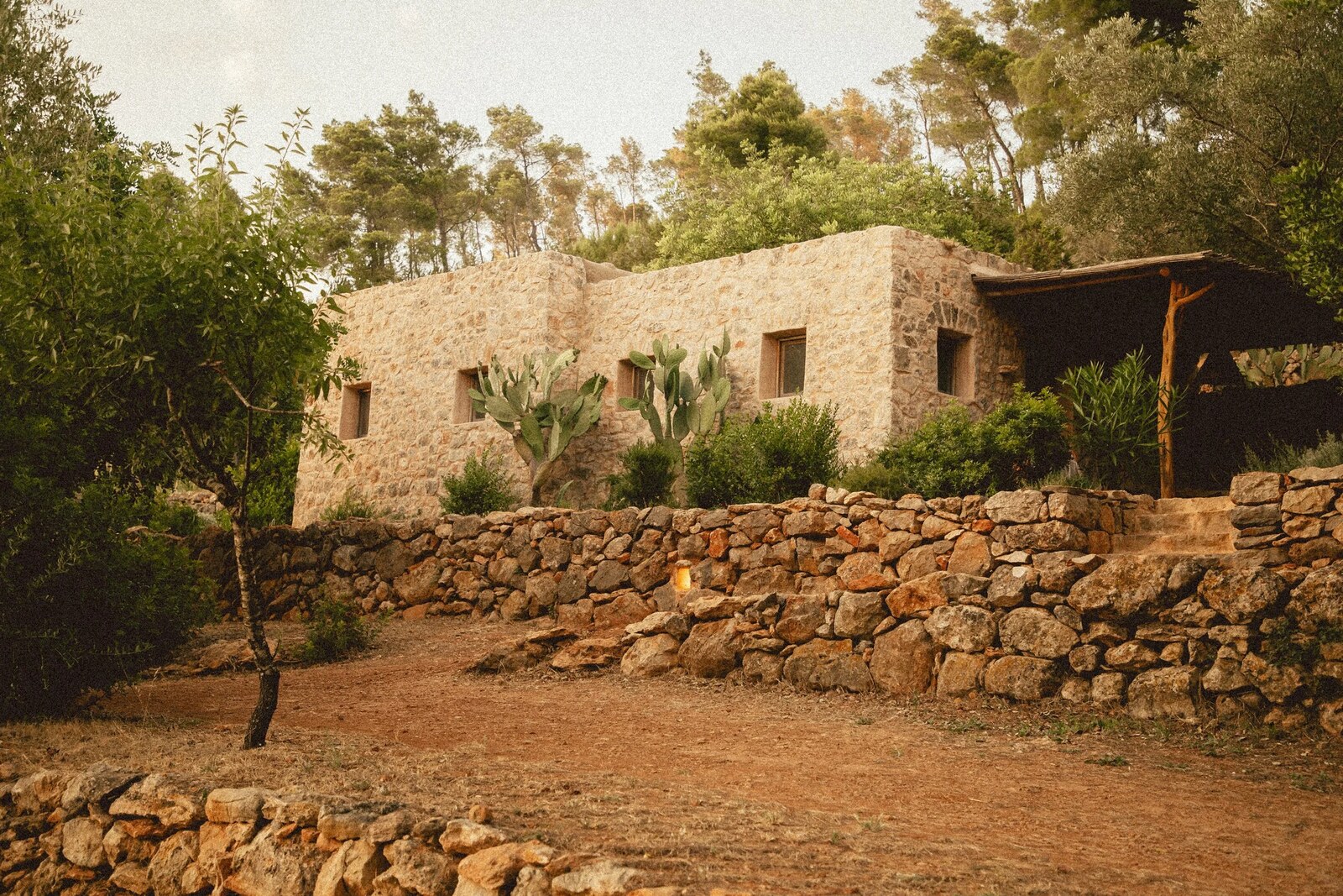Can Domo &mdash; the old stone finca set into the hillside above dry-stone terraces