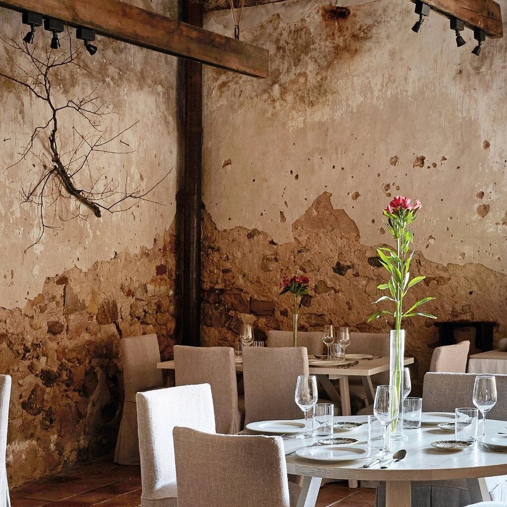 Casa Taberna — restaurant tables set against bare, aged stone walls