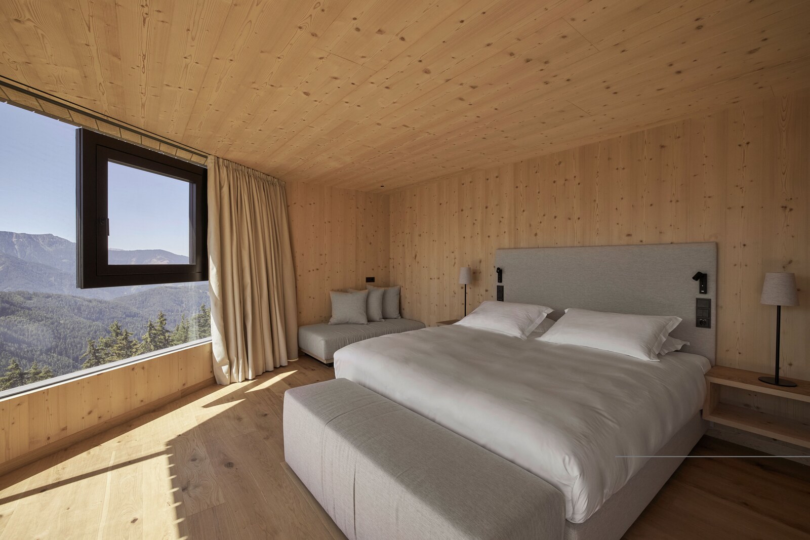 Forestis — spruce-clad bedroom with mountain view