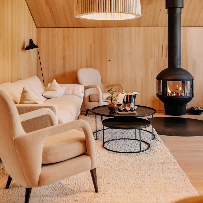 Naturhotel Forsthofgut — a suite lounge around a suspended fireplace