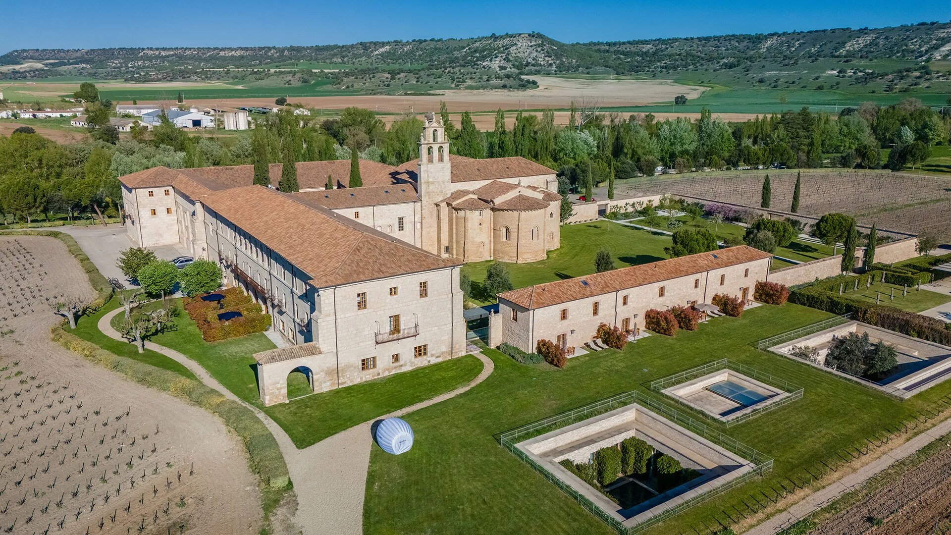 Abad&iacute;a Retuerta &mdash; abbey from the air, vineyards beyond