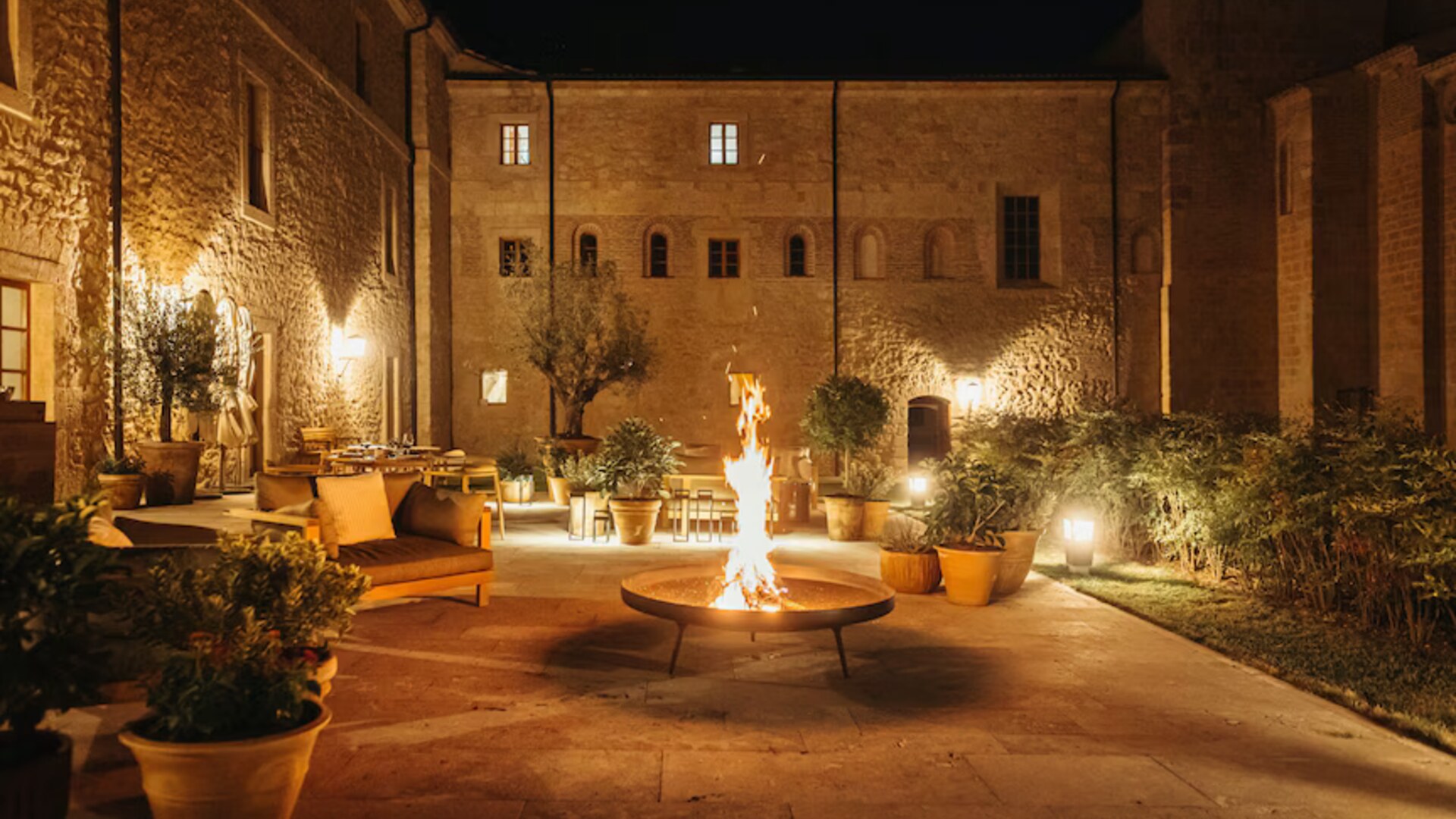 Abad&iacute;a Retuerta &mdash; courtyard firepit after dark
