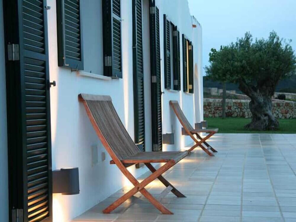 Biniguas Vell &mdash; the terrace at dusk beneath an olive tree