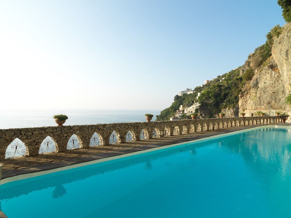 Borgo Santandrea &mdash; the long pool beneath an arcaded terrace
