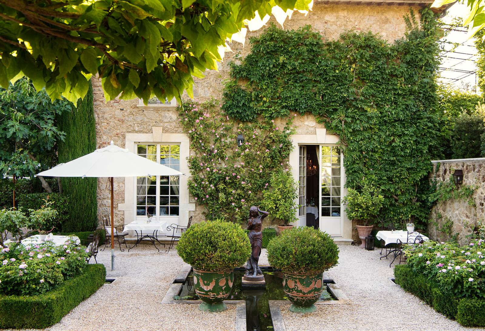 Borgo Santo Pietro &mdash; an ivy-clad courtyard and parasols