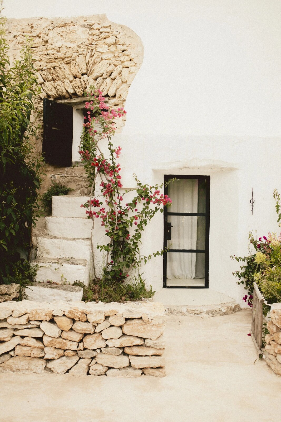 Can Domo &mdash; whitewashed finca walls, stone steps and bougainvillea