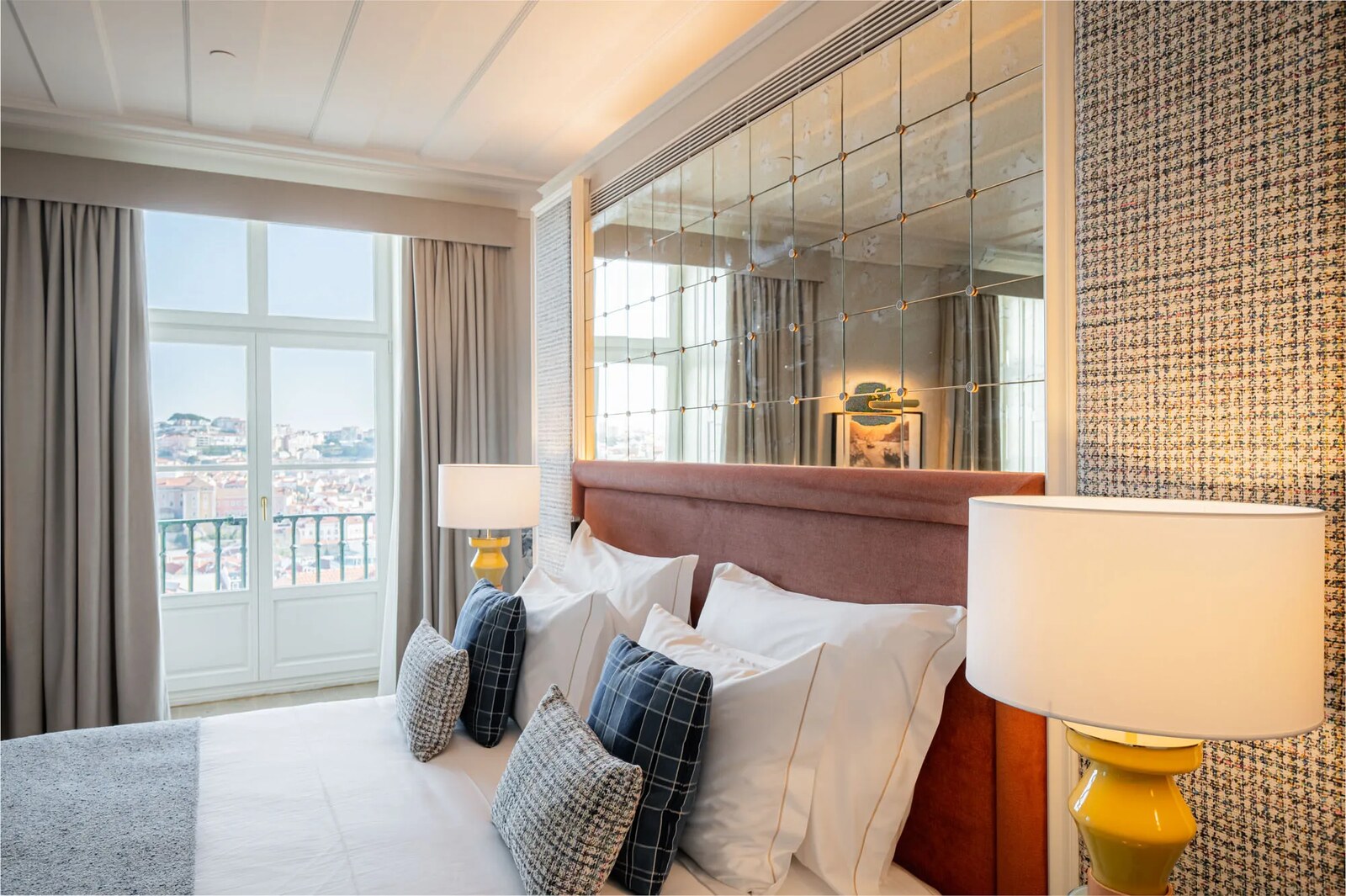 Pal&aacute;cio Ludovice &mdash; a bedroom with tall windows over the city