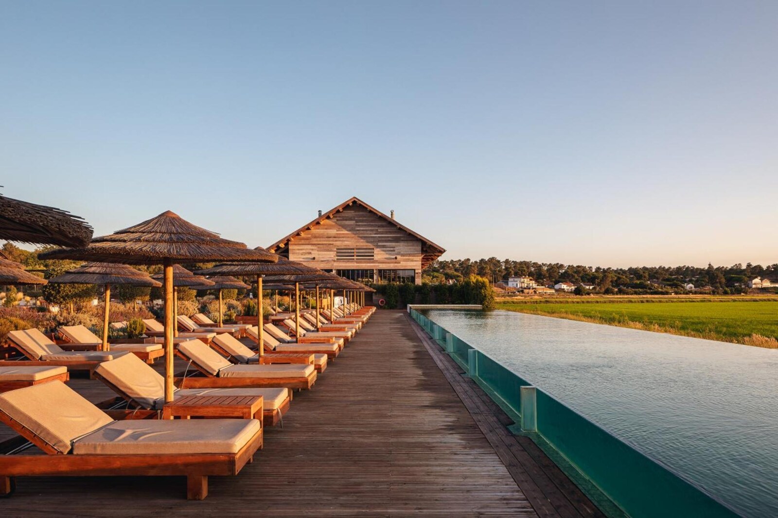 Quinta da Comporta &mdash; the long pool running out towards the rice fields at sunset