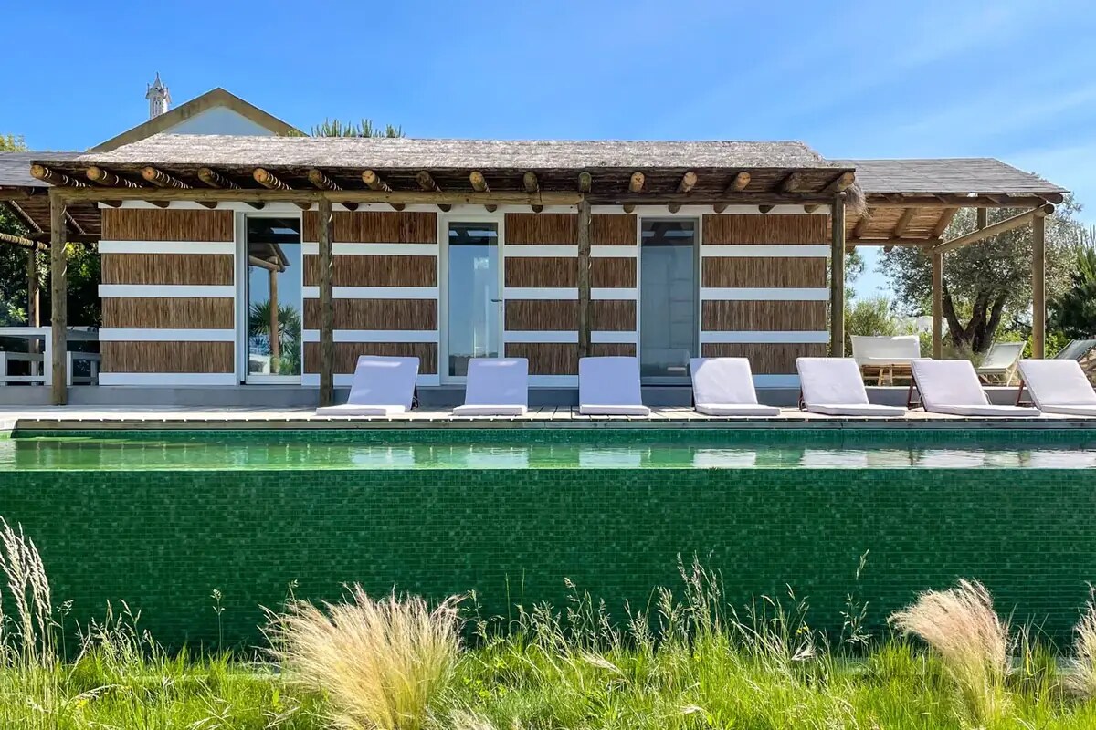 Sublime Comporta &mdash; the long pool and loungers beneath the umbrella pines