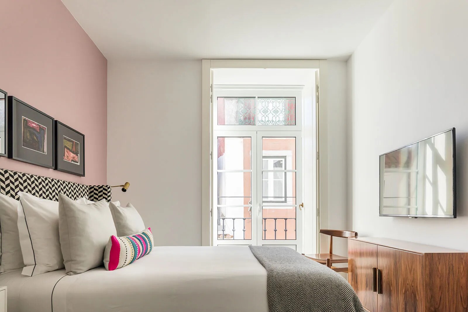 The Lumiares &mdash; a bedroom with a balcony over the Bairro Alto rooftops