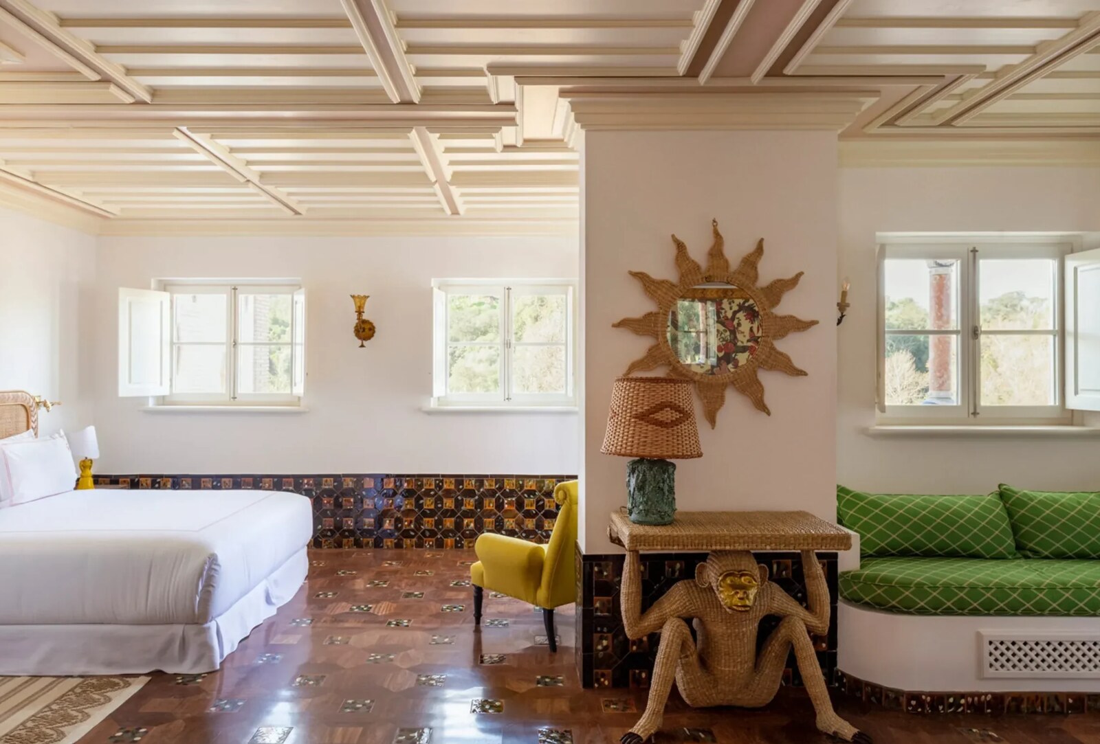 Vermelho Melides &mdash; a bedroom with a gilded sunburst mirror and patterned tiled floor