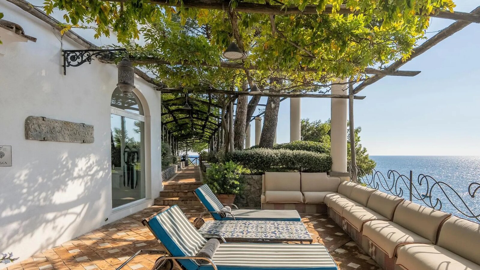 Villa Treville &mdash; a pergola-shaded terrace looking out to sea