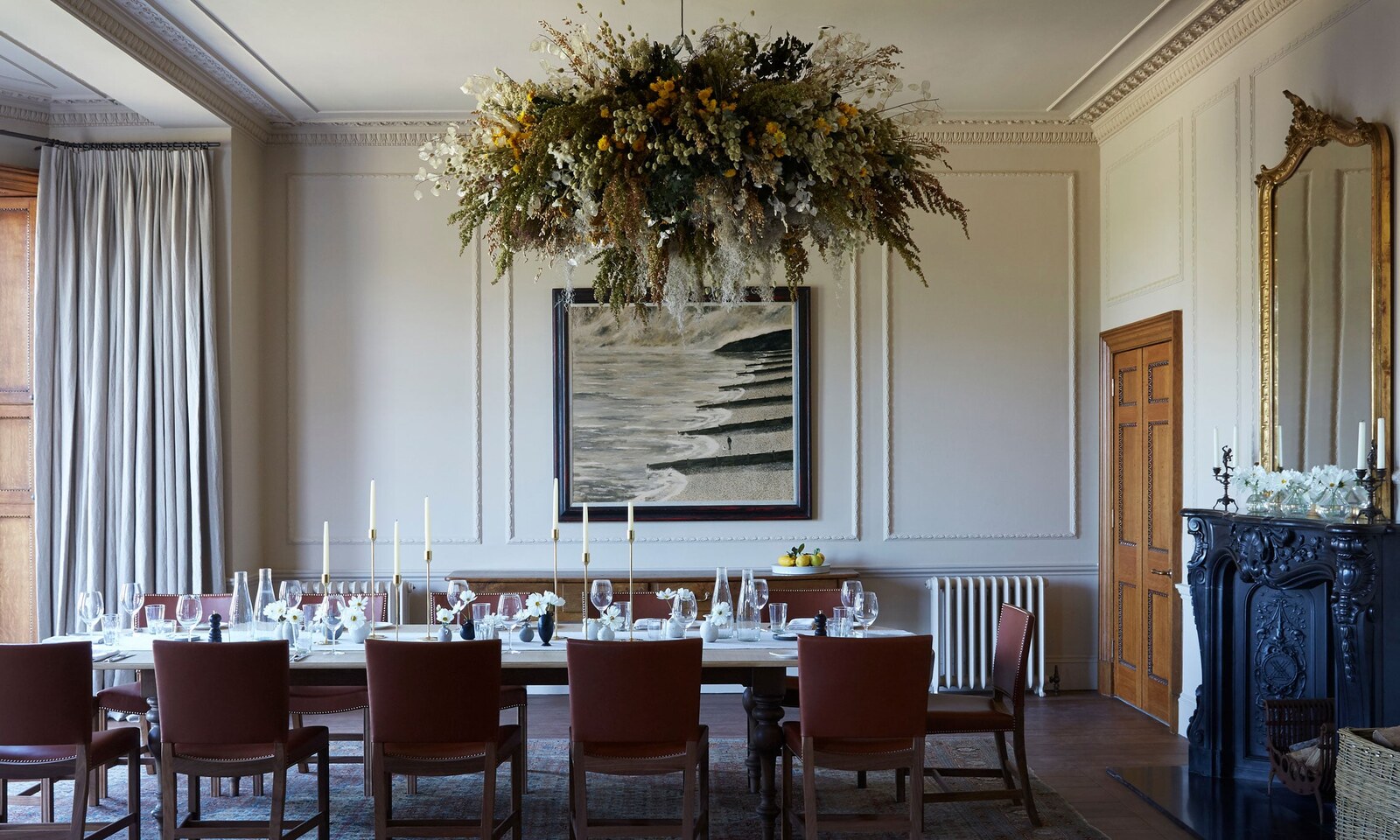 The formal dining room beneath a dried-flower chandelier