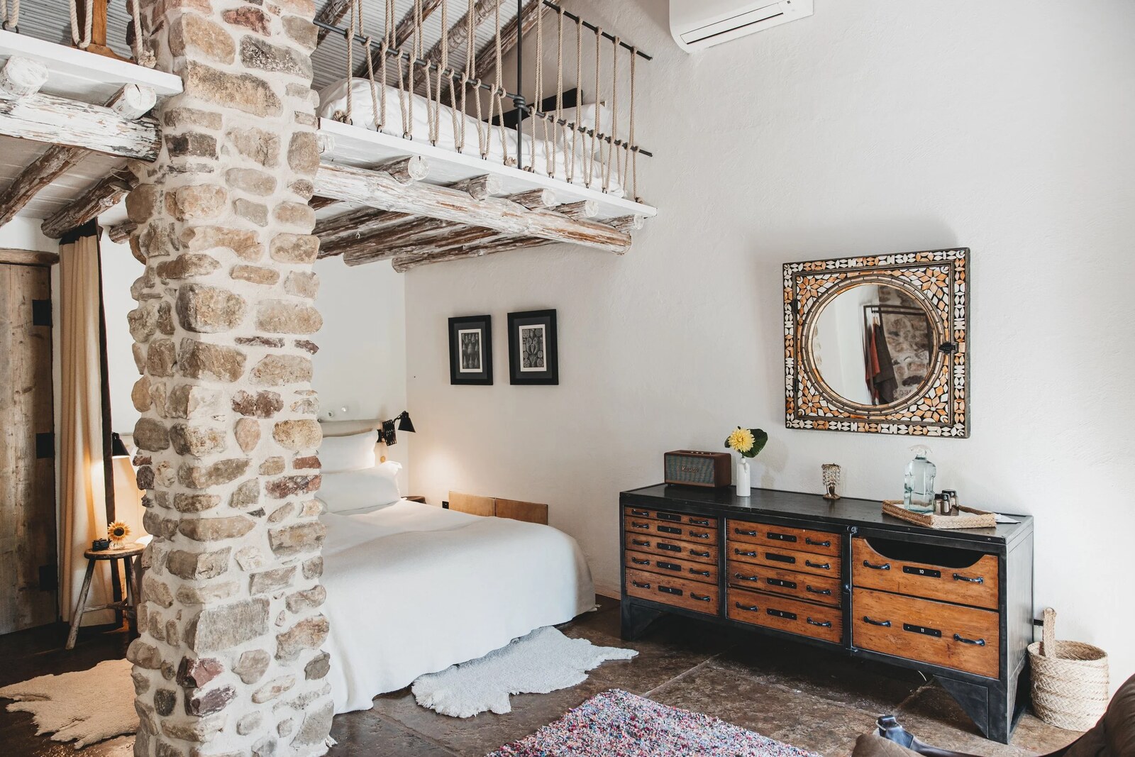 La Donaira &mdash; a whitewashed bedroom with exposed stone