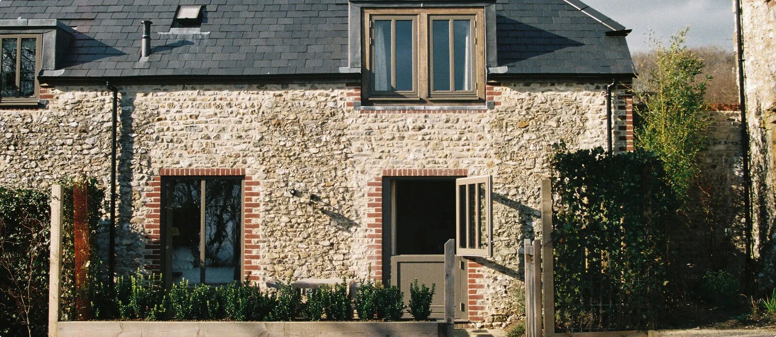 Louma — a flint-and-stone barn conversion with brick dressings