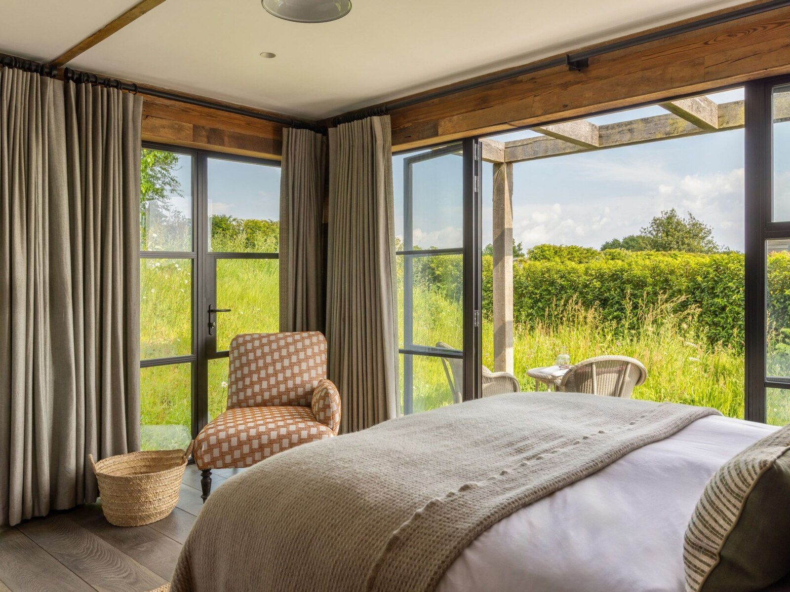 Louma — a bedroom opening onto Dorset wildflower meadow