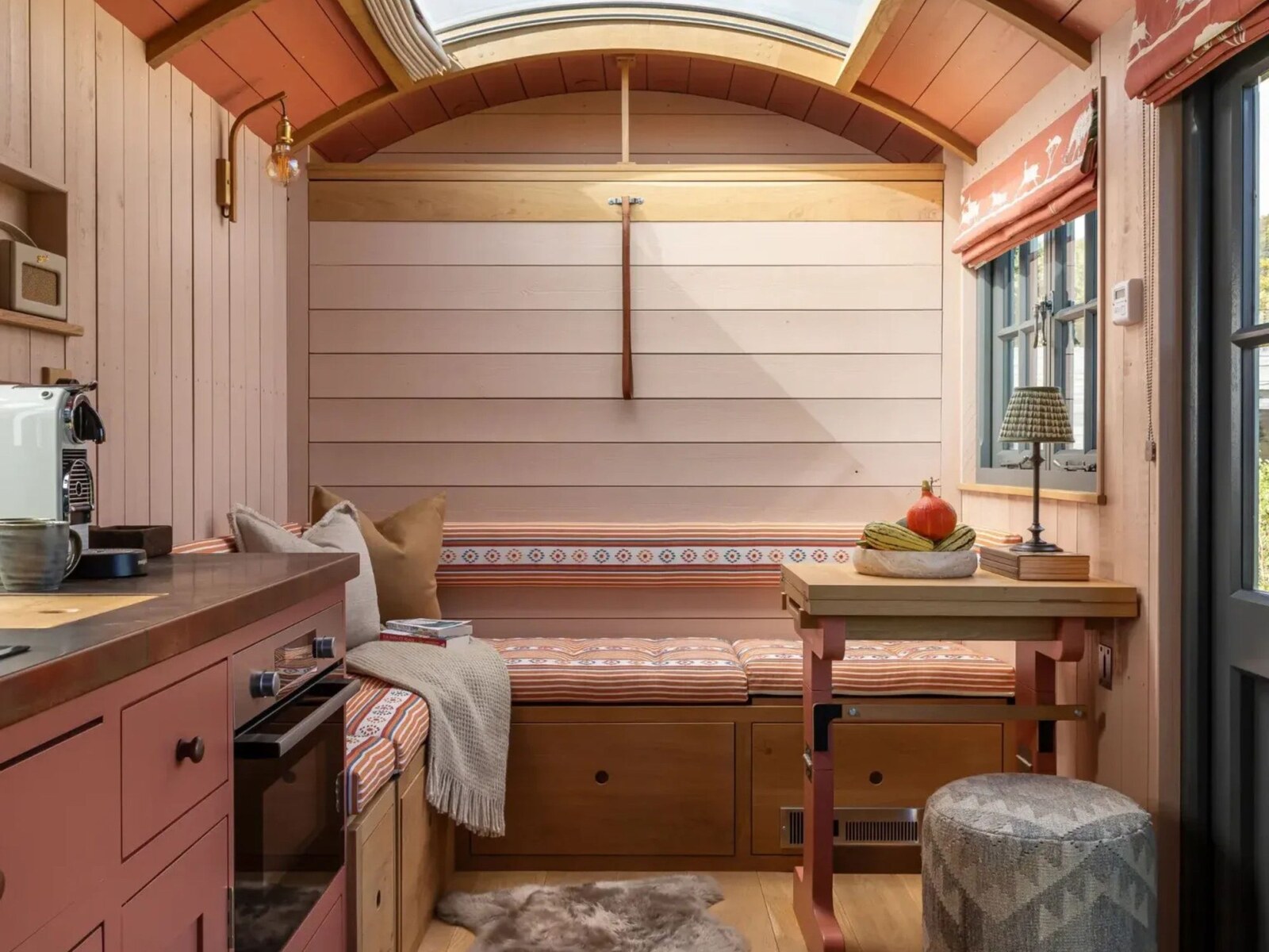 Louma — a shepherd's hut interior panelled in soft terracotta