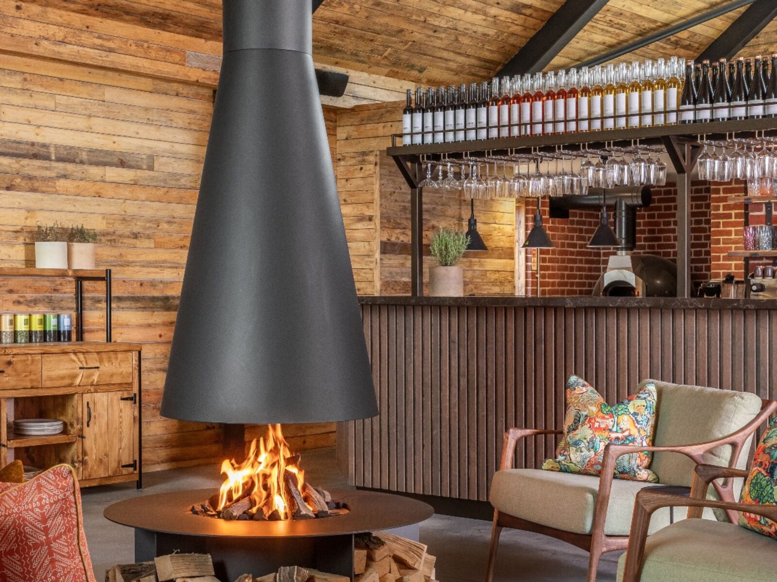 Louma — the bar and cyder room with its black conical fireplace