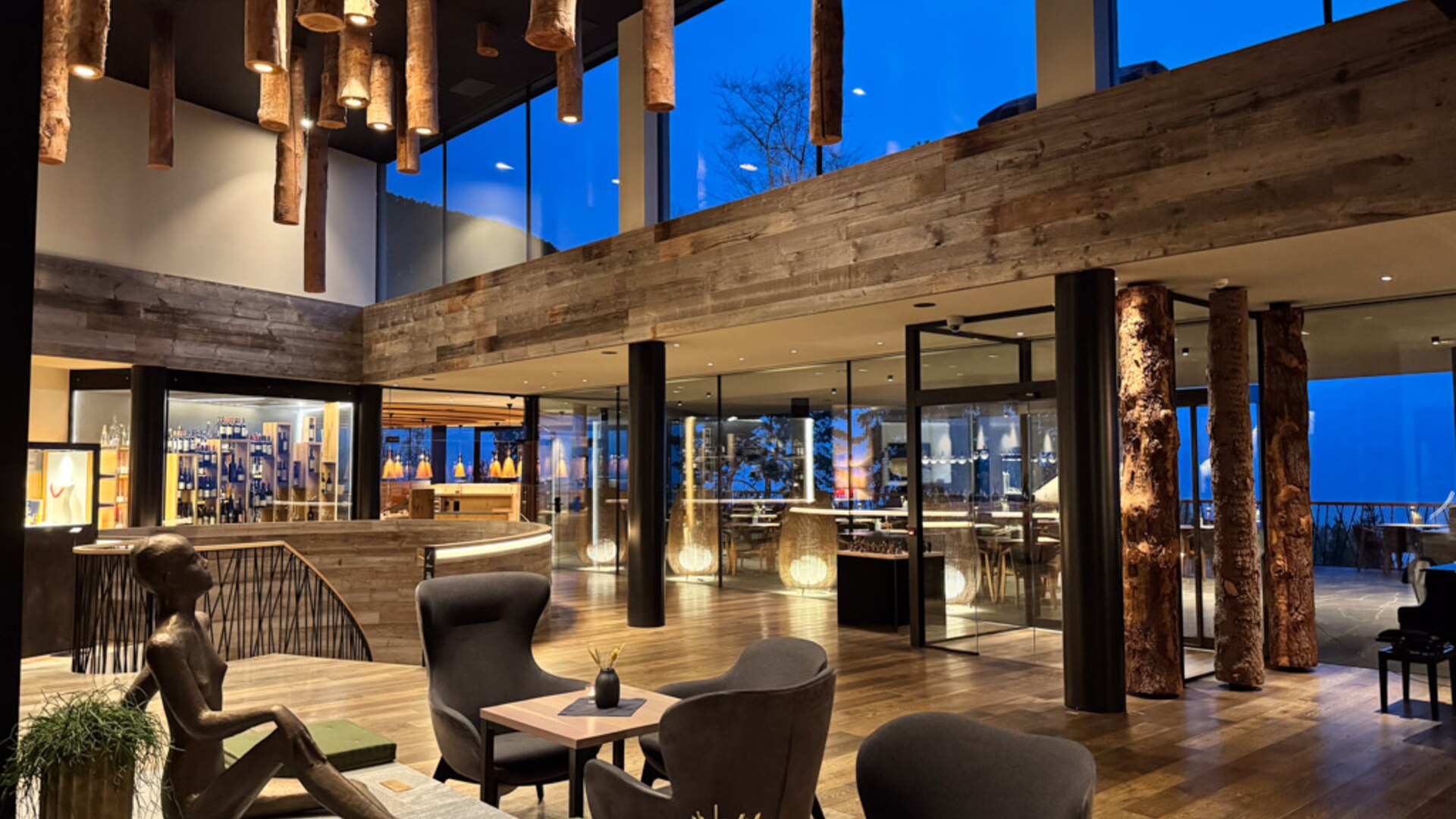 MyArbor — lobby with tree-trunk columns at dusk