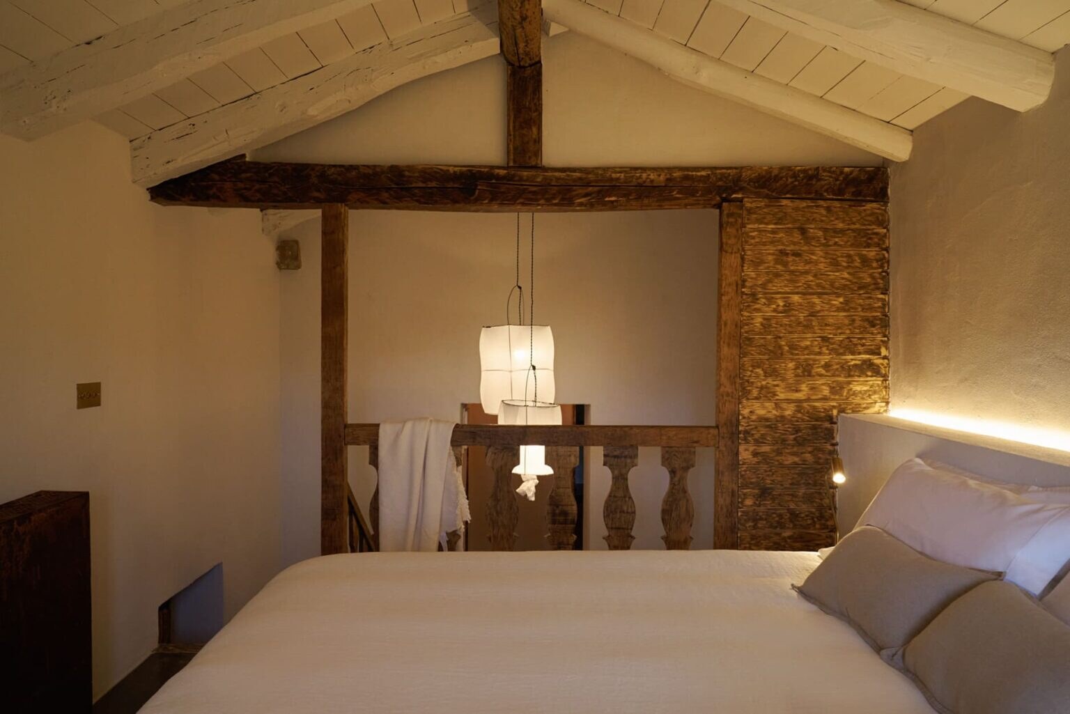 Solo Palacio — beamed attic bedroom under a pitched timber roof