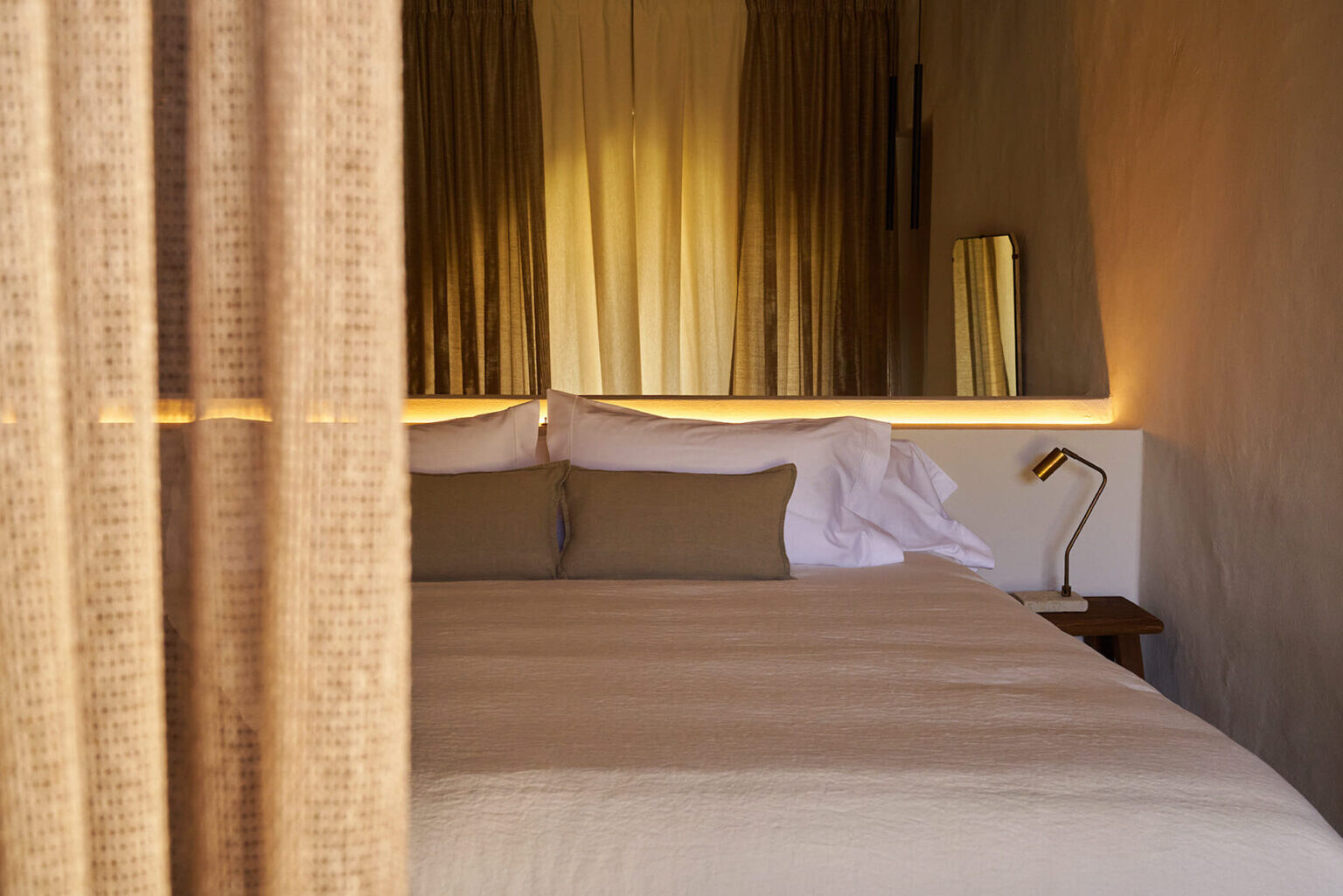 Solo Palacio — loft bedroom with a softly backlit headboard