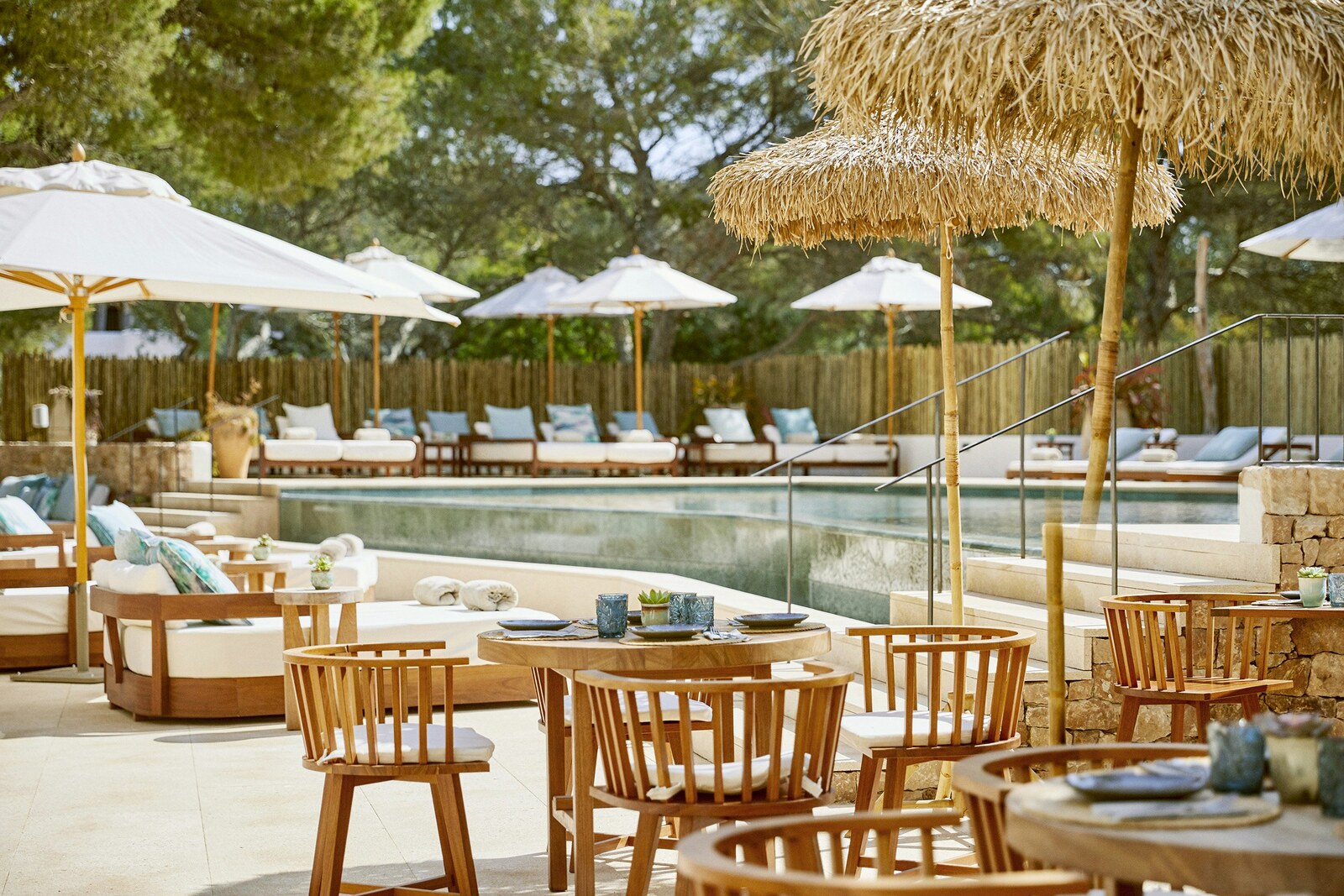 Teranka &mdash; the pool and dining terrace beneath thatched parasols