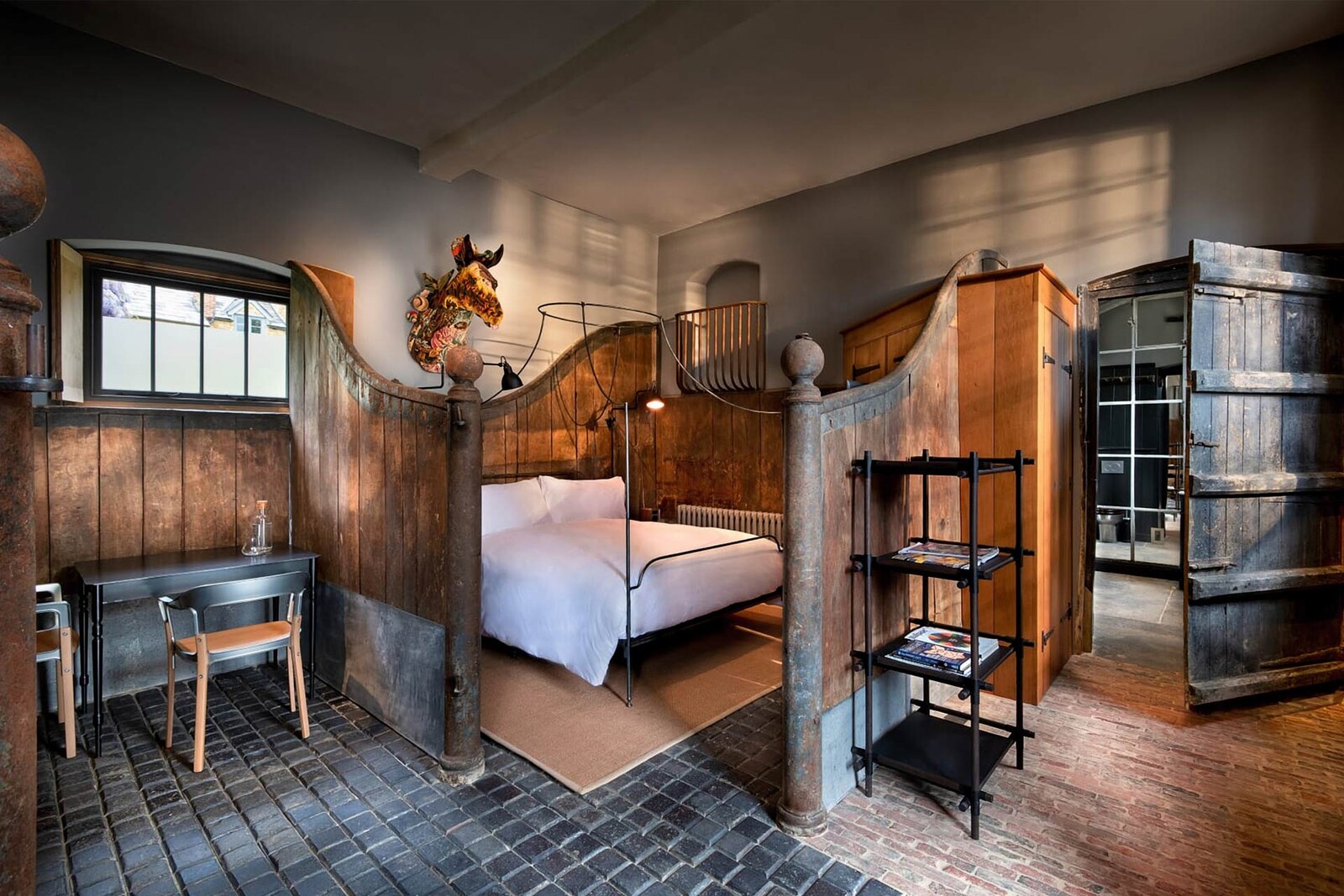 The Newt in Somerset — the Stable Room, with reclaimed timber stalls and a cobbled floor