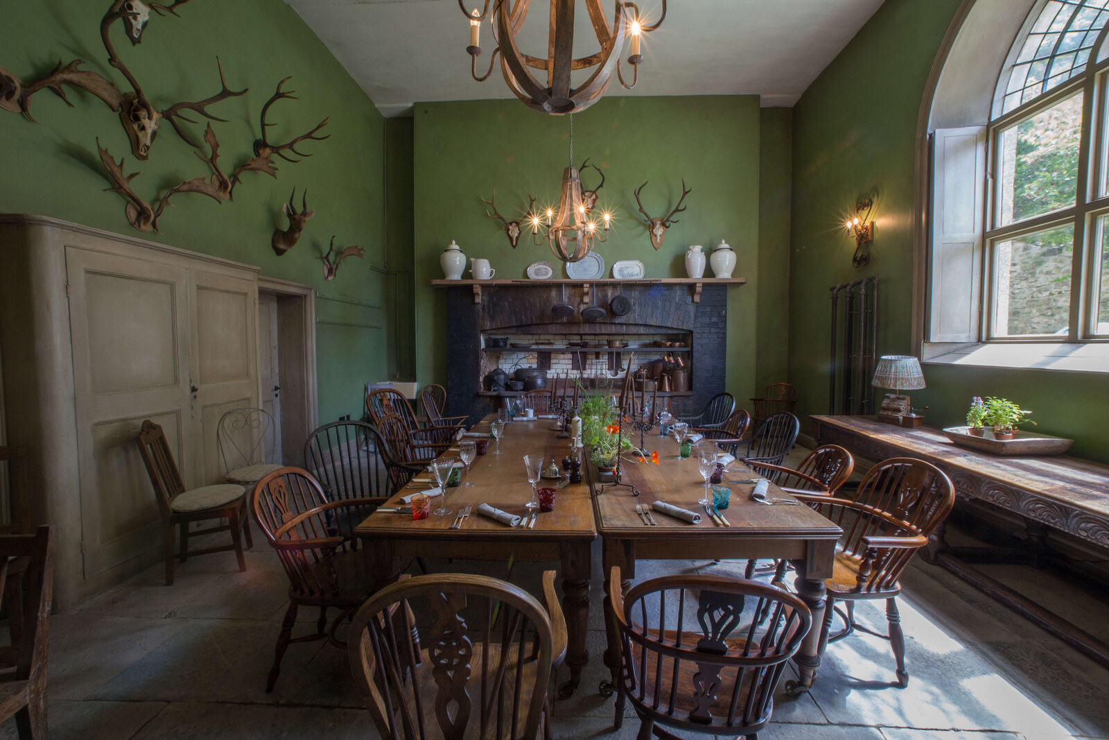 The Pig — the green Georgian dining room hung with antlers and set with Windsor chairs