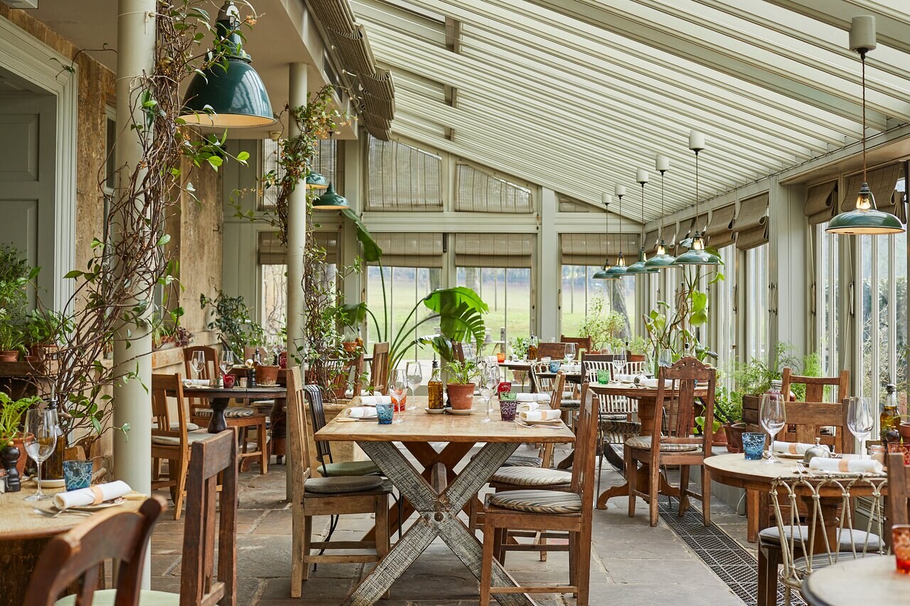 The Pig — the greenhouse restaurant full of plants and pendant lights