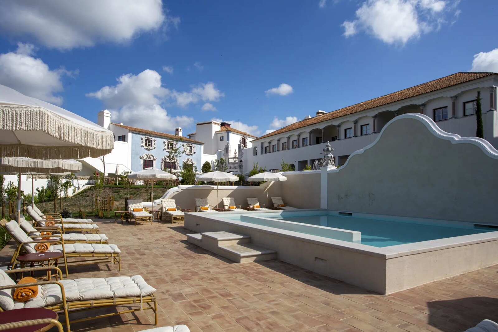 Vermelho Melides &mdash; the pool set among whitewashed buildings with red trim