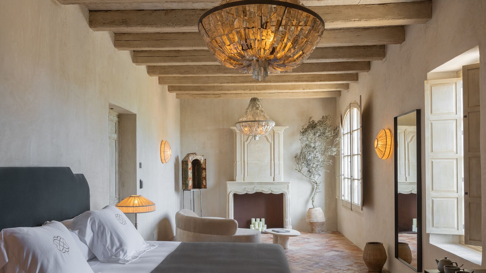 Vestige Son Vell — suite with beamed ceiling, sculptural chandelier and a stone fireplace