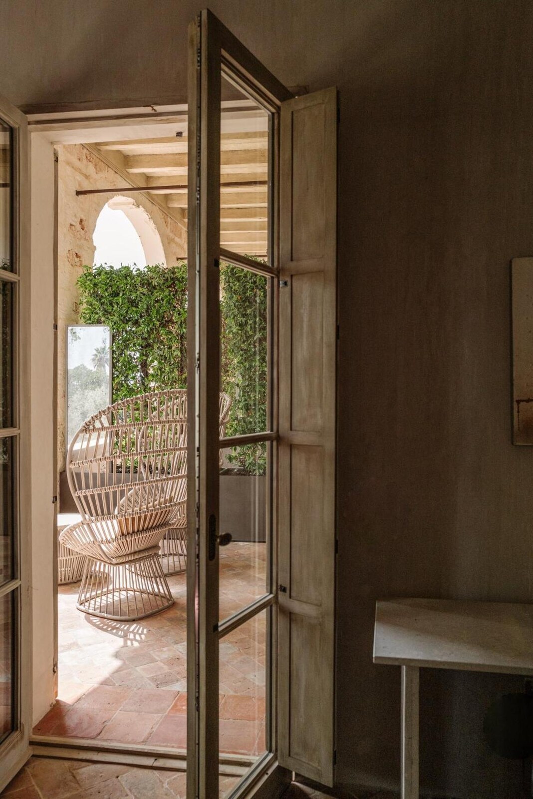 Vestige Son Vell — shuttered doors opening onto a private terrace with rattan chairs