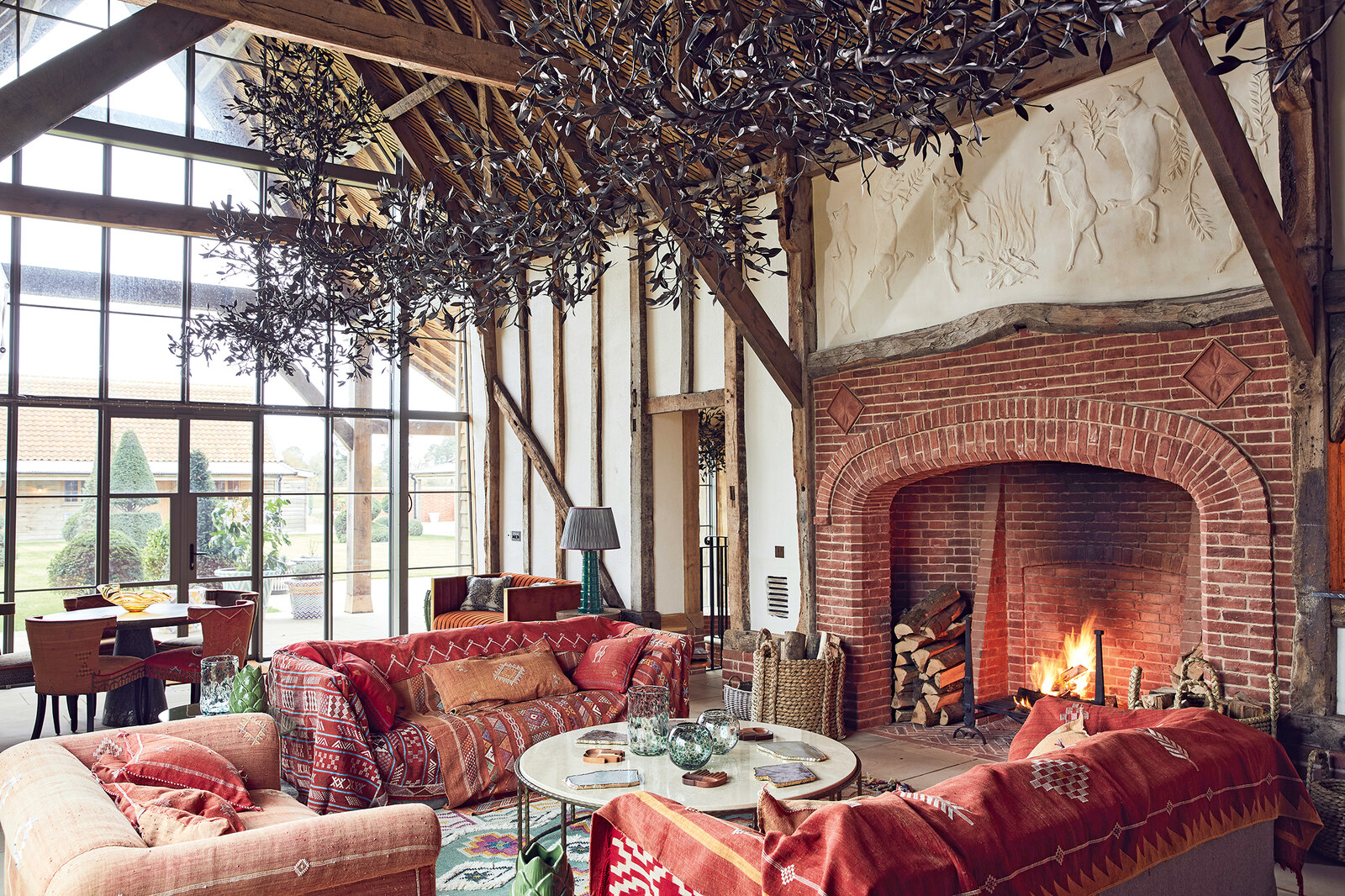 Wilderness Reserve — barn living room with open fire and timber frame