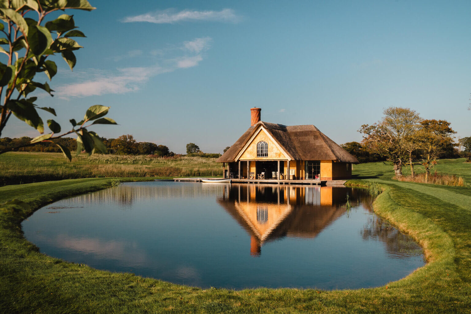 Wilderness Reserve — thatched boathouse mirrored in still water