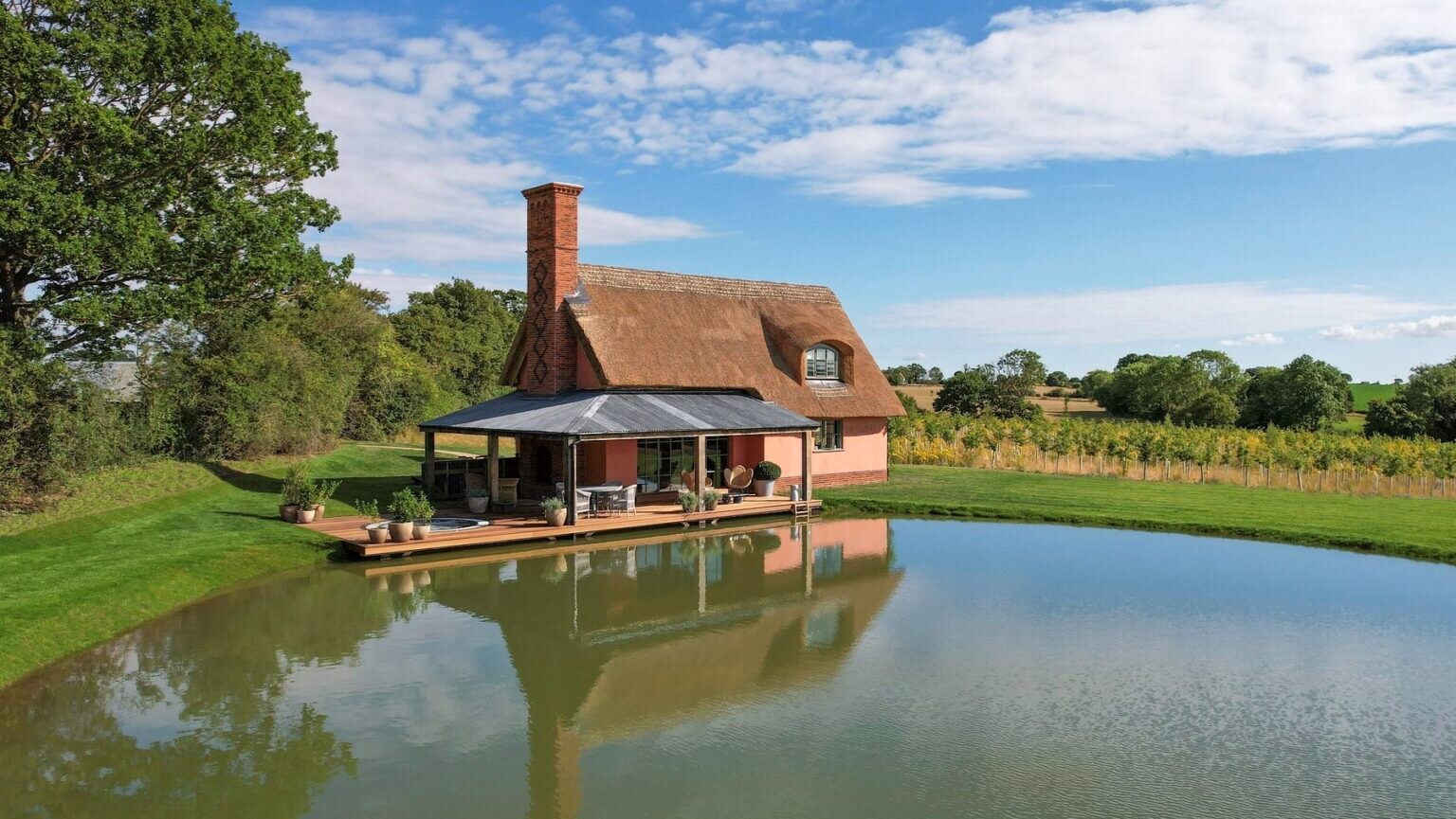 Wilderness Reserve — pink thatched cottage on the water's edge